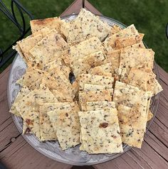 a plate full of crackers sitting on top of a wooden table