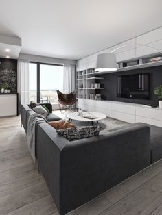 a living room filled with furniture and a flat screen tv mounted on a wall above a fireplace