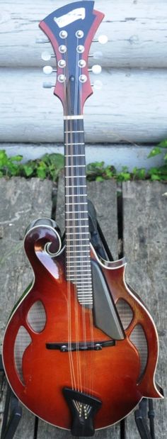 an old guitar sitting on top of a wooden table