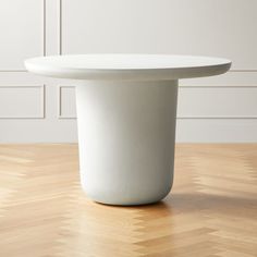 a white table sitting on top of a wooden floor