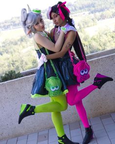 two women dressed in costumes posing for the camera