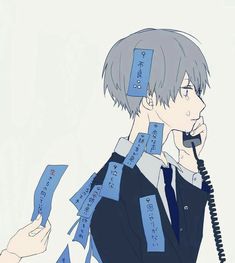 a man talking on a phone surrounded by blue papers