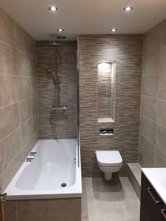 a bathroom with a toilet, sink and bathtub in the middle of the room