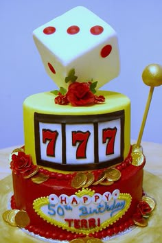 a birthday cake made to look like a casino machine with two dices on top