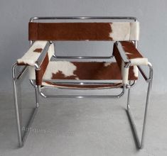 a brown and white chair sitting on top of a cement floor