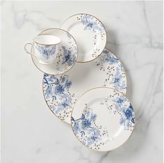 three blue and white porcelain dishes on a marble surface