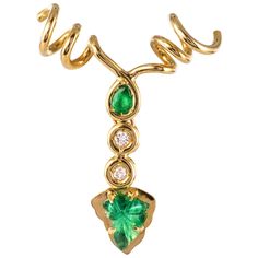 Pendant in 18 karat yellow gold. This gold pendant is intended for a lover of the vineyard. It represents a coiled vine stock set on the front with a bezel-set motif with a pear-cut emerald, 2 modern brilliant-cut diamonds, and a flat gold motif retaining an engraved leaf emerald at 4 claws. . Total diamond weight: approximately 0.06 carat. Height: Approximately 3.4cm, Width: Approximately 2.5cm, Thickness: Approximately 6.4mm. Total weight of the jewel: approximately 4.1 g. Pendant sold alone, Emerald Diamond Pendant, Gold Motif, Vine Leaves, The Vineyard, Diamond Cross Pendants, Sapphire Pendant, Cluster Pendant, Key Pendant, Leaf Pendant