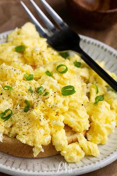 an egg salad is on a plate with a fork