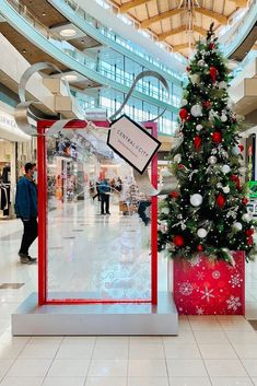 a christmas tree in the middle of a shopping mall