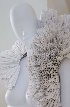 a close up of an object made out of plastic straws on a white surface