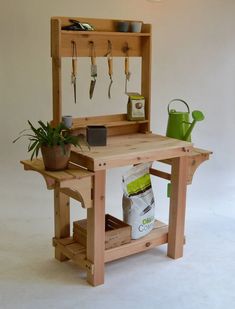 a wooden workbench with gardening tools on it