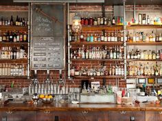 the bar is stocked with many different types of liquors and beverages, including gin