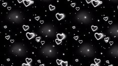 many hearts are floating in the air on a black background with stars and sparkles