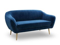 a blue velvet couch with wooden legs