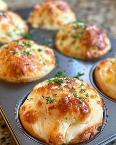 mini cheese rolls in a muffin tin with parsley on top