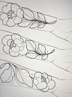 three flower designs on white paper with black ink