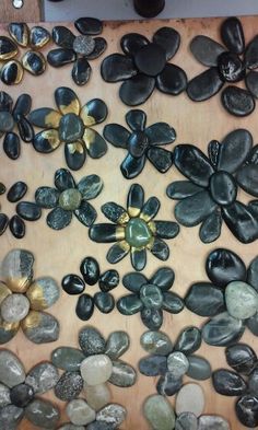 several different types of stones are arranged on a wooden board