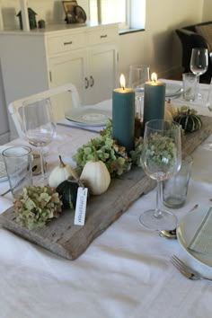 the table is set with candles and place settings