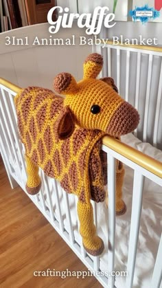 a crocheted giraffe stuffed animal hanging from the side of a crib