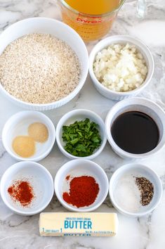 the ingredients are in small white bowls on the marble counter top, including rice, broccoli, and other spices