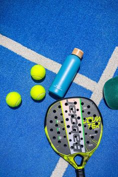 a tennis racket and balls on a court