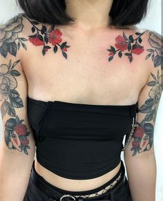 a woman with black hair and tattoos on her chest