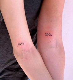 two people with tattoos on their arms that have numbers tattooed on each arm and the number twenty