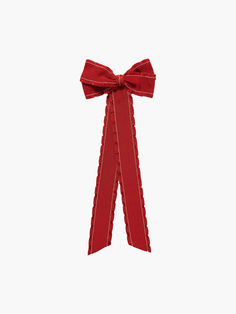 a red ribbon tied to the side of a white wall with a bow on it