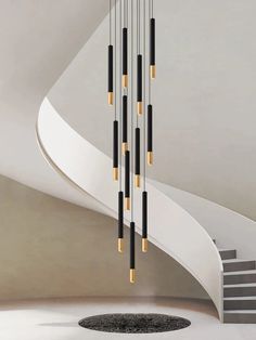 a modern chandelier with black and gold rods hanging from it's ceiling