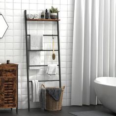 a bathroom with white tile walls and flooring next to a wooden shelf filled with towels