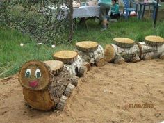 a group of logs sitting on top of a dirt field