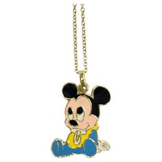 a mickey mouse necklace is shown on a gold chain with a blue and yellow shirt