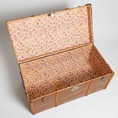 an old suitcase with floral fabric on it