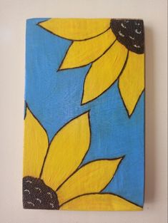 a painting of two yellow flowers on a blue background