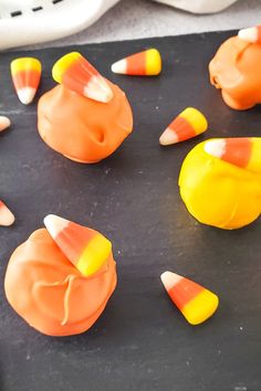 candy candies are arranged in the shape of pumpkins on a baking sheet, ready to be eaten