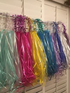 many different colored streamers are hanging on the wall