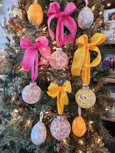 a christmas tree decorated with ornaments and bows