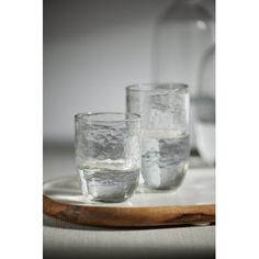 three glasses on a tray with ice in them