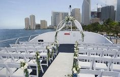 an outdoor ceremony setup on the back of a boat