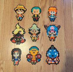 six pixelated characters are displayed on a wooden surface