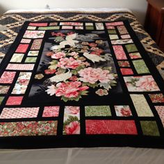 a bed with a quilt made to look like flowers