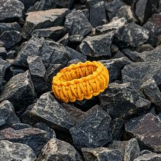 a yellow ring sitting on top of some rocks