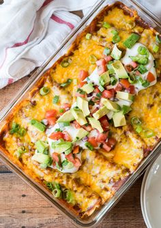 an enchilada casserole with avocado and tomatoes