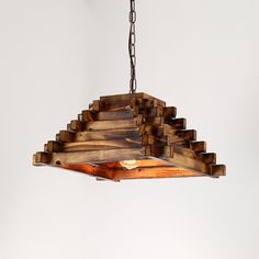 a wooden light fixture hanging from a chain