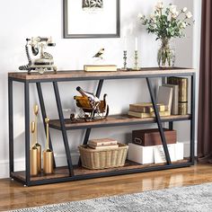 a shelf with some books and other items on it in a room next to a window