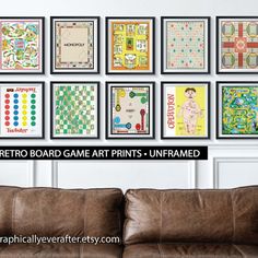 a couch sitting in front of a wall covered in pictures and text reading retro board game art prints unframed