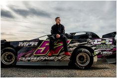 a man sitting on top of a racing car