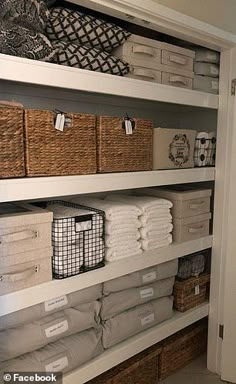 an organized closet with baskets and towels