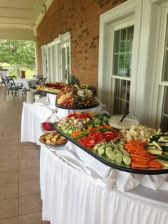 an outdoor buffet with many different types of vegetables