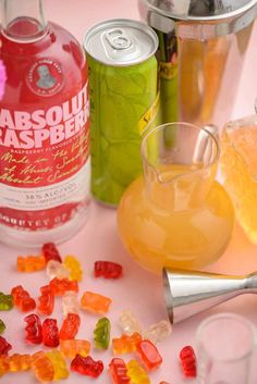 various types of gummy bears and drinks on a table